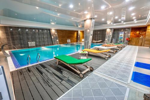 a swimming pool with two chaise lounges and a swimming pool at GVC New Gudauri Alpic Mountain view in Gudauri