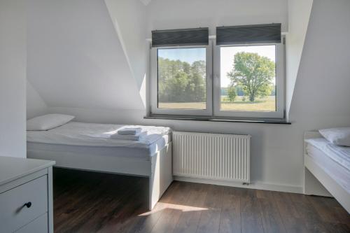 Ένα ή περισσότερα κρεβάτια σε δωμάτιο στο Apartamenty Zielona Lipka