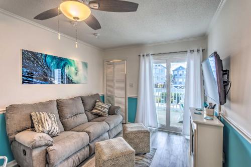 a living room with a couch and a tv at Surfside Beach Escape with Pool - Walk to Ocean! in Myrtle Beach