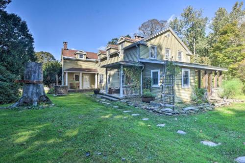 an old house with a tree in the yard at Waterfalls and Trails at The Mills At Green Hole in Hillsdale