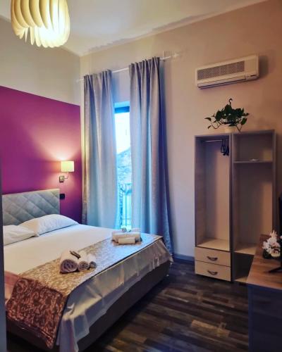 a bedroom with a bed and a window with shoes on it at Casa tua suites in Catania