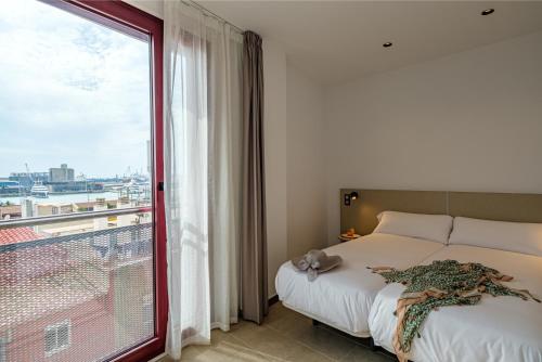 a bedroom with a bed and a large window at Tgna Reial 1 in Tarragona