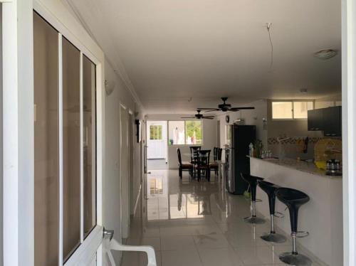 a kitchen and dining room with a counter and stools at Hotel West Plaza in Santa Marta