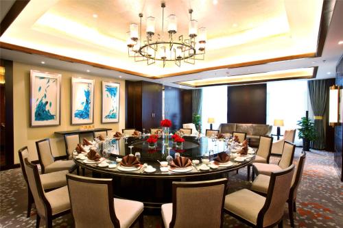 a conference room with a large table and chairs at Grand Barony Xi'an in Xi'an