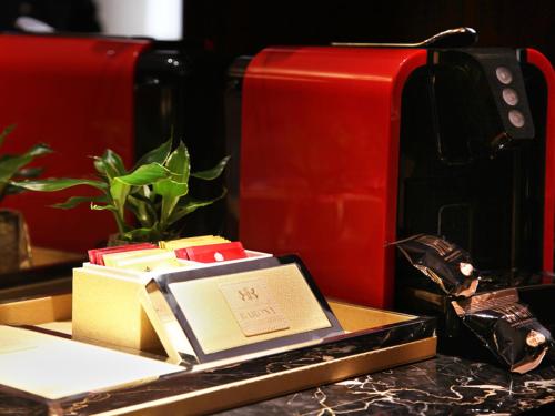 a book sitting on a tray next to a toaster at Grand Barony Xi'an in Xi'an