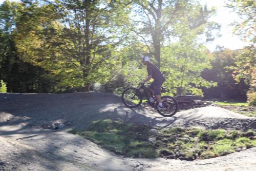 a man riding a bike on a dirt road at Tälta Lodge, a Bluebird by Lark in Stowe