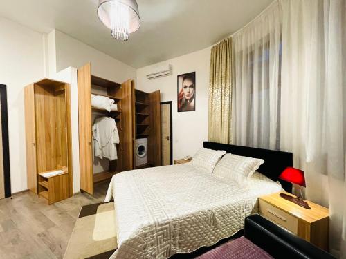a bedroom with a large bed and a closet at Apartments & Villa Georg in Odesa