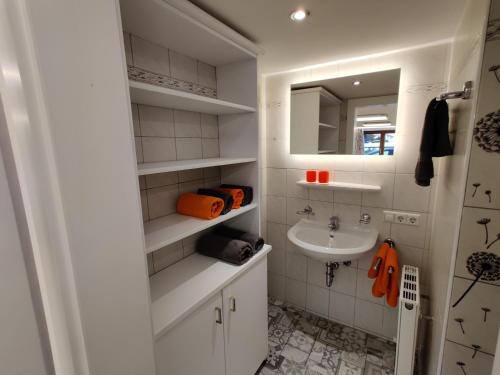 a white bathroom with a sink and a mirror at Appartements Berger Kitzbühel in Kitzbühel