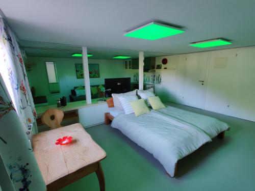a bedroom with a bed and a table and green lights at Appartements Berger Kitzbühel in Kitzbühel