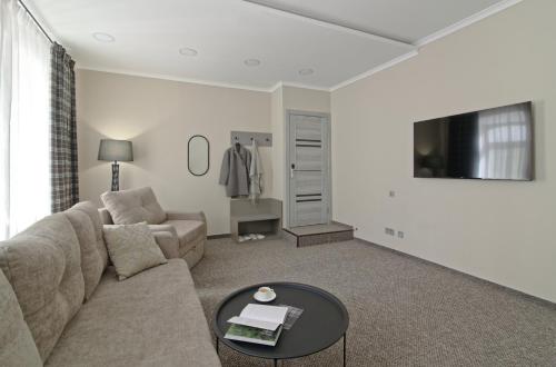 a living room with a couch and a table at Deribas Hotel in Odesa