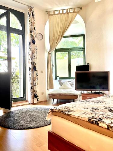 a bedroom with a bed and a large window at City Center Leipzig II in Leipzig