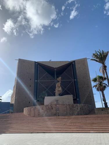 a building with a statue in front of it at Villa Rosaura in Las Palmas de Gran Canaria