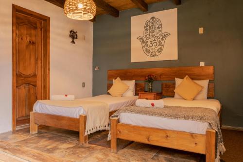 A bed or beds in a room at Hospedaje Boutique Paz Creativa