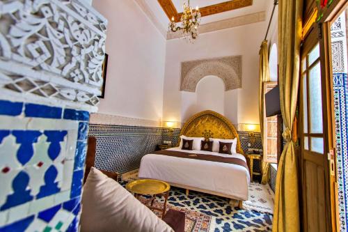 a hotel room with a bed and a couch at Riad Marjana suites & Spa in Fez