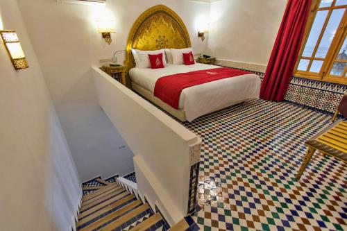 a hotel room with a bed and a staircase at Riad Marjana suites & Spa in Fez
