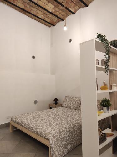 Ένα ή περισσότερα κρεβάτια σε δωμάτιο στο Al Portico