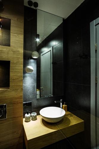 a bathroom with a bowl sink and a mirror at 4-Bedroom Luxury Apartment in New Gudauri in Gudauri
