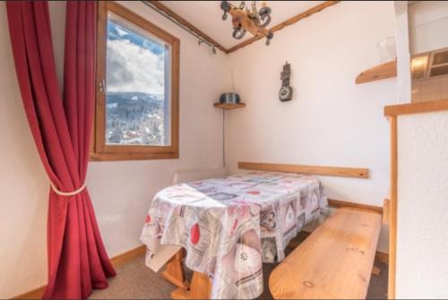 a room with a table and a window at Résidence Saboia Courchevel La Tania - Belle Vue in Courchevel