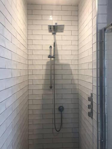 a bathroom with a shower with a shower head at HAYFIELD COTTAGE spacious detached luxury home in Copmanthorpe