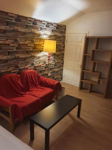 a living room with a red couch and a table at 17A DB Airbnb in Wexford