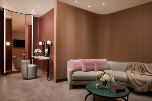 a living room with a couch and a table at Pan Pacific London in London