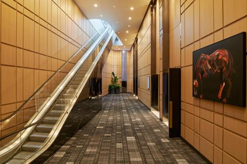 an empty hallway with stairs in a building at Pan Pacific London in London
