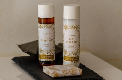 two bottles of hair products sitting on a black tray at Rossio Plaza Hotel in Lisbon