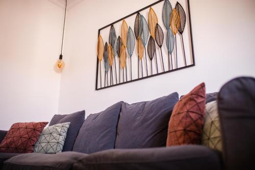 a living room with a couch with pillows on it at Canary Treasure La Laguna exclusiveness prime location in La Laguna