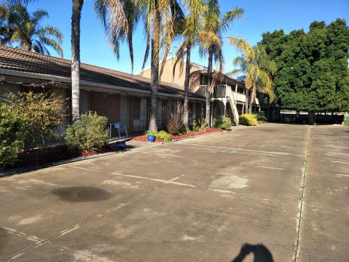 a shadow of a person standing in a parking lot at Darling Junction Motor Inn in Wentworth