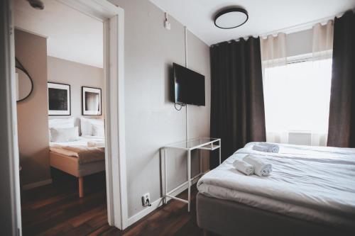 a hotel room with a bed and a mirror at Siljansnäs Hotell in Siljansnäs