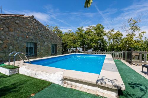 a swimming pool in the yard of a house at Casa Jurinea in Torres