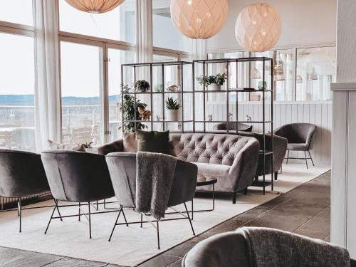 a living room with a couch and a table and chairs at Siljansnäs Hotell in Siljansnäs