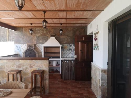 a kitchen with a counter and wooden ceiling at Casa rural La Pradera in Villanueva de la Concepción