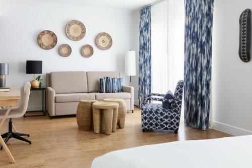 a living room with a couch and a chair at Kimpton Angler’s Hotel South Beach by IHG in Miami Beach