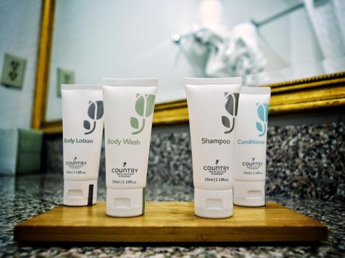 a group of four products on a wooden table at Country Inn & Suites by Radisson, Grand Rapids Airport, MI in Grand Rapids