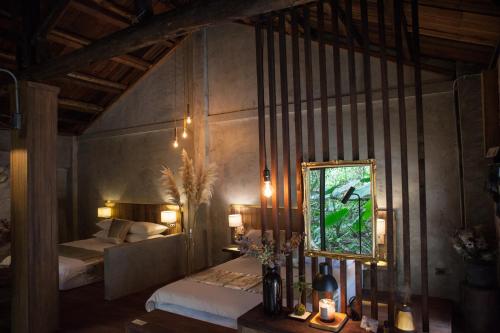 a bedroom with a bed and a mirror on the wall at Twilight Forest in Jiufen