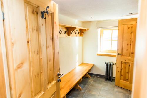 a room with a wooden bench and a window at Alpine Lodge Sölden - Chalet & Apart in Sölden