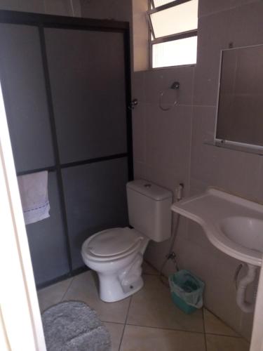 a bathroom with a toilet and a sink at Mayda hostel in Praia Grande