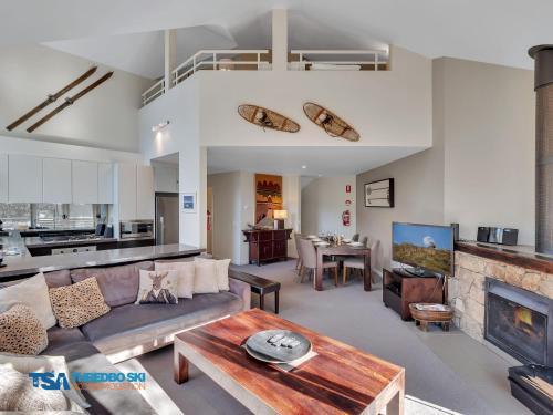 a living room with a couch and a table at Wintergreen 5 in Thredbo