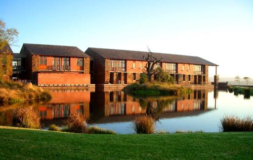 a building next to a body of water at Riboville Boutique Hotel And Restaurant in Midrand
