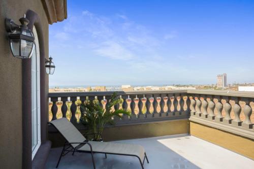 a balcony with a chair and a view of the ocean at The Hotel Oceanside in Oceanside
