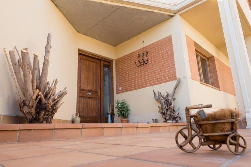 a bike parked in front of a building with a door at Finca Olivar de Castilla - Sun&Colors in Segovia