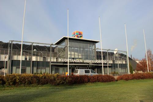 a building with a van parked in front of it at Kuortaneen Urheiluopisto in Kuortane