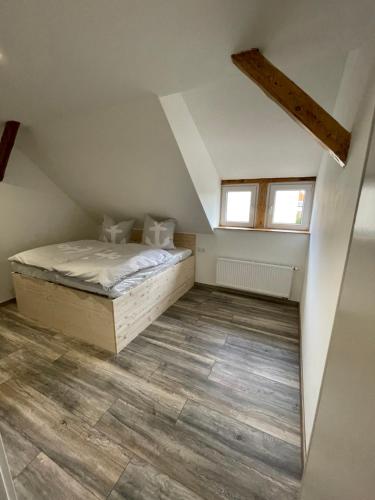 a bedroom with a bed in a attic at Linus und seine Ferienwohnungen 2 in Heldrungen