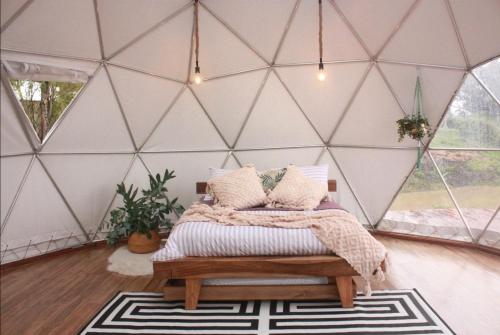 a bedroom with a bed in a tent at Amatea de Villa de Leyva in Villa de Leyva