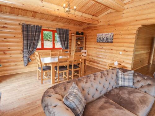 a living room with a couch and a table in a cabin at Maple Lodge in Oakham