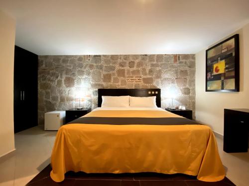 Ένα ή περισσότερα κρεβάτια σε δωμάτιο στο Hotel Escala Puebla Centro