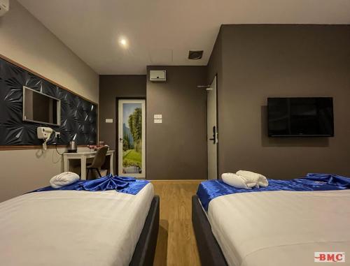 Voodi või voodid majutusasutuse BMC Hotel toas