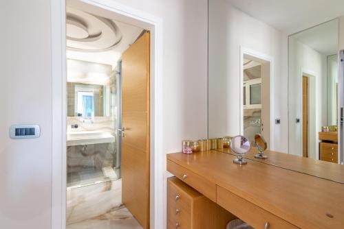 a bathroom with a vanity and a sink and a mirror at Candia Boulevard in Heraklio Town
