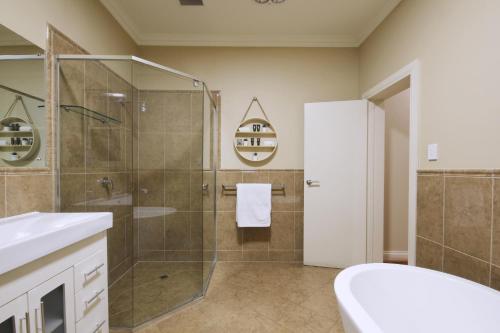 a bathroom with a shower and a sink at Whyalla Playford Apartments in Whyalla